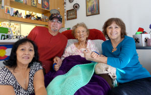 104-year-old resident Rafelita sits with with her family in her Mercy Housing home.