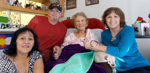 104-year-old resident Rafelita sits with with her family in her Mercy Housing home.