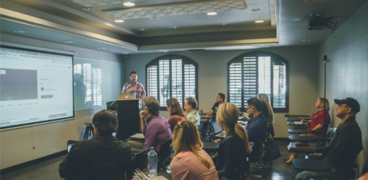 A photo of people sitting at a presentation