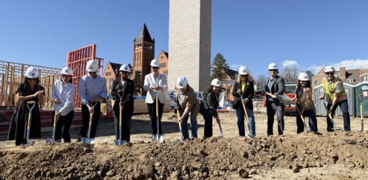 People wearing hats outside and breaking ground