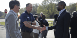 Grand Opening and people shaking hands