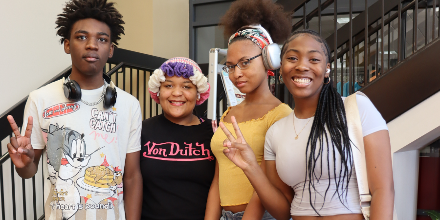 A group of college students smiling at a tour