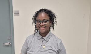 A resident leader, Leevora, smiles for the camera 