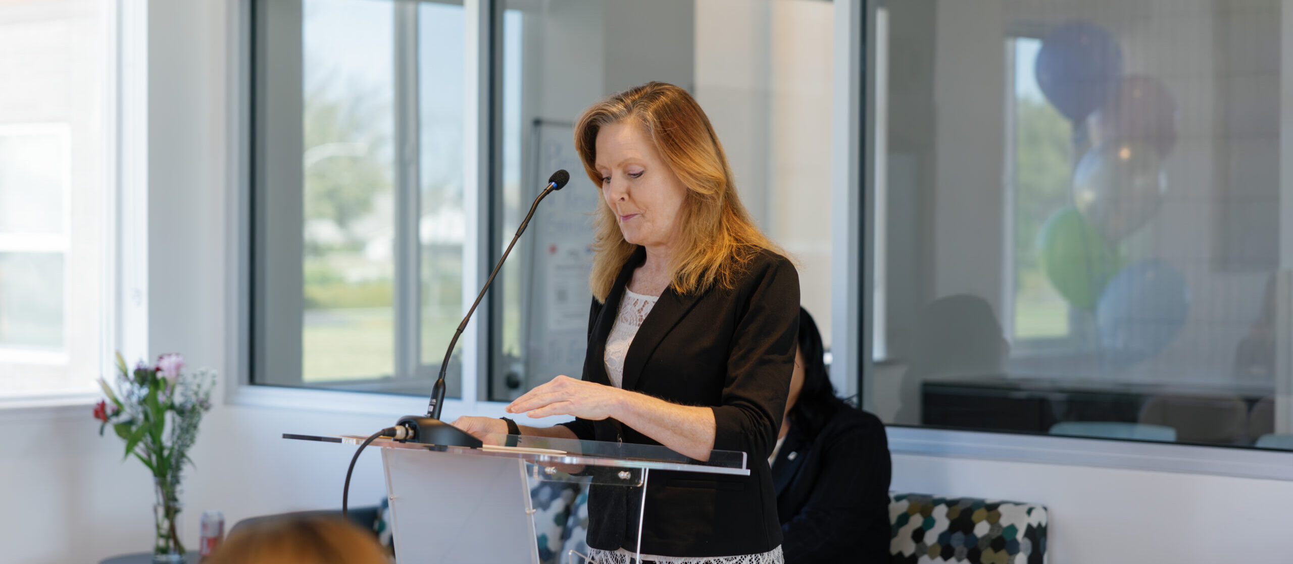 Cerise speaking at a podium